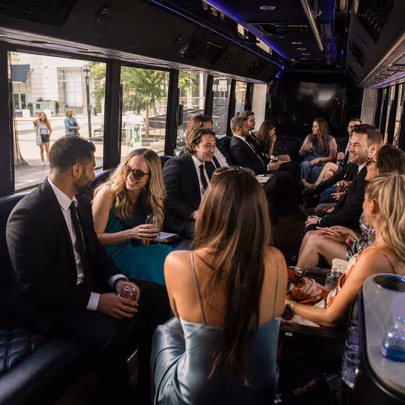 Wedding guests seated inside a Dallas party bus