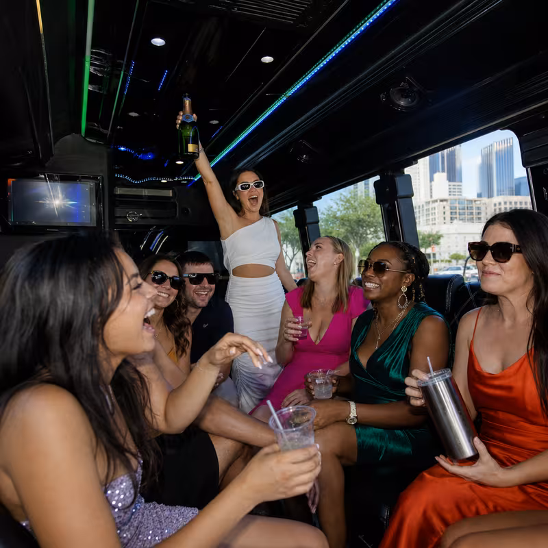 Party bus interior with wraparound leather seating and LED lighting in Dallas