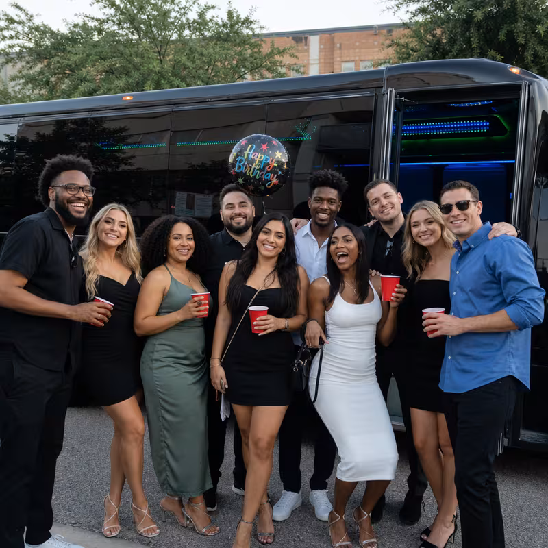 Group boarding a white charter bus for Birthday Transportation transportation in Dallas