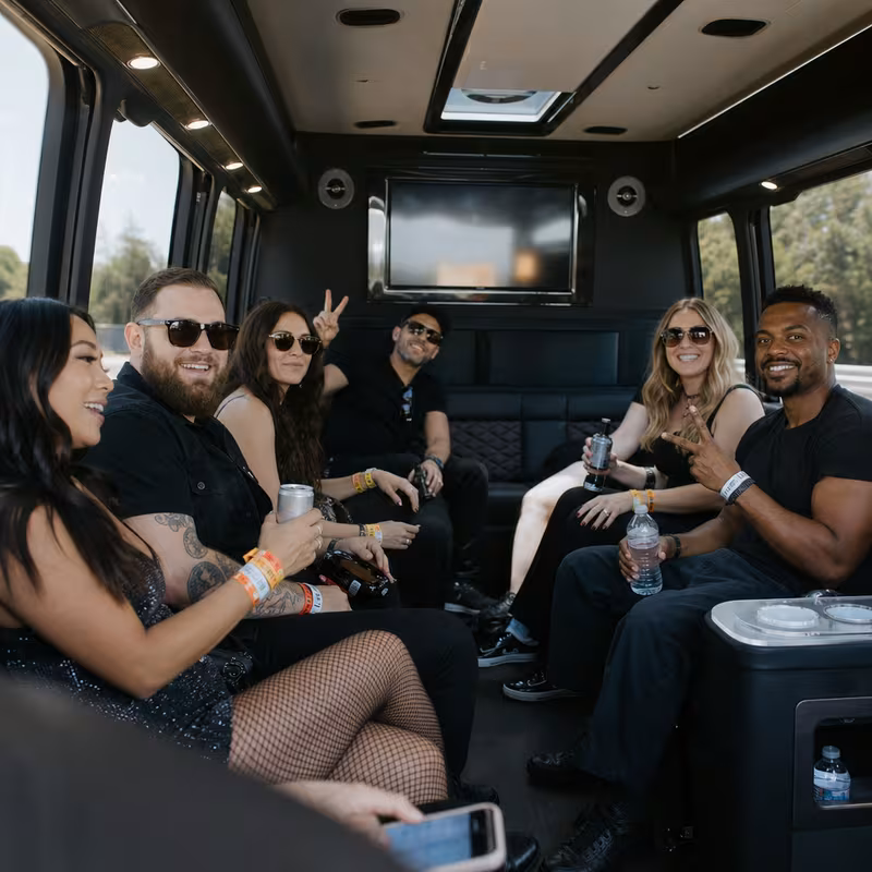 Group boarding a white charter bus for Concert Transportation transportation in Dallas