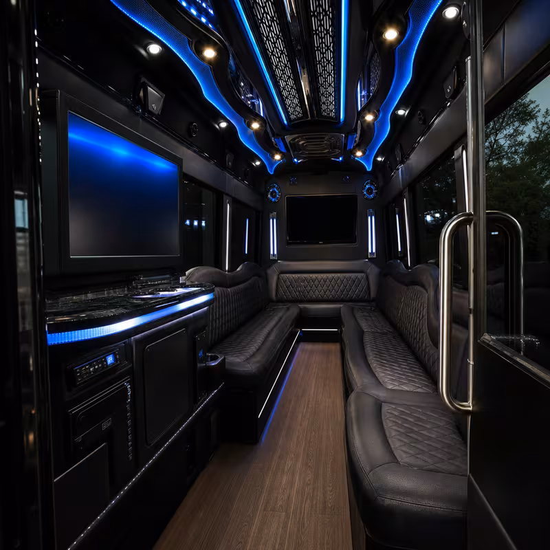 Party bus interior with wraparound leather seating and LED lighting in Dallas