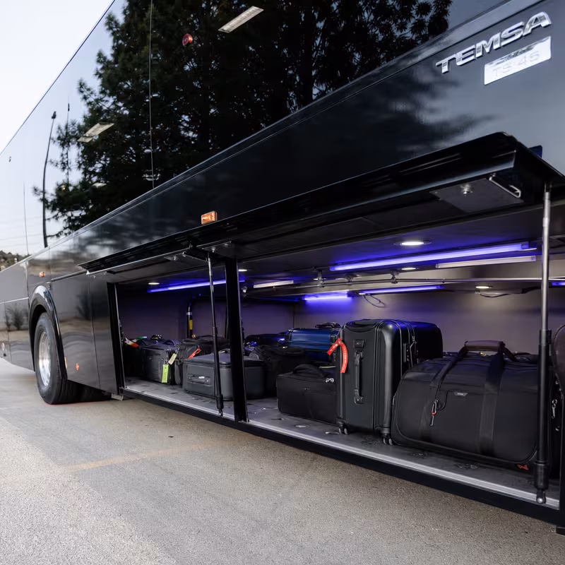 Party bus interior with wraparound leather seating and LED lighting in Dallas