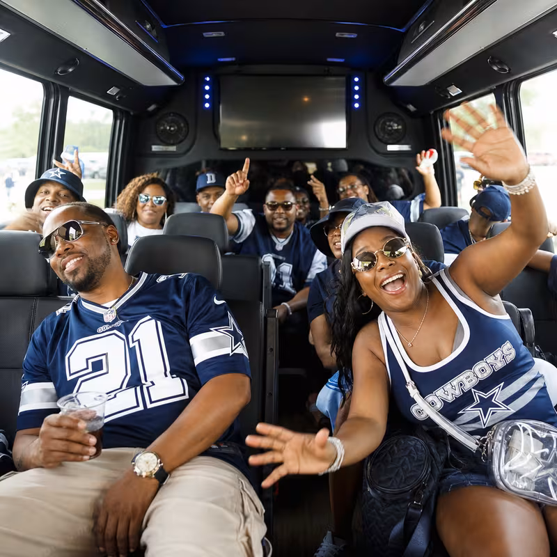 Group boarding a white charter bus for Sporting Event Transportation transportation in Dallas