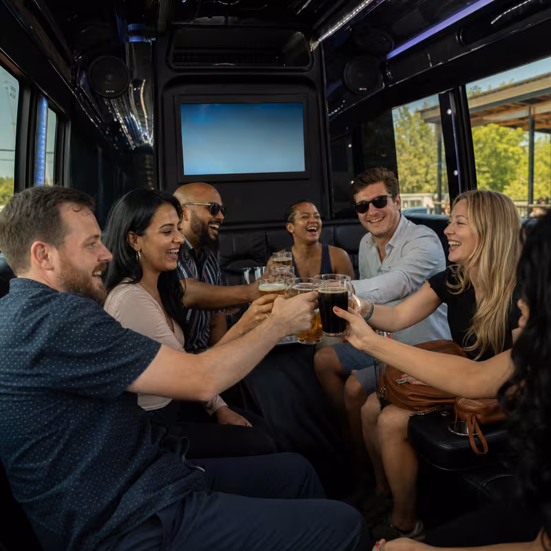 Group boarding a white charter bus for Winery & Brewery Tour Transportation transportation in Dallas